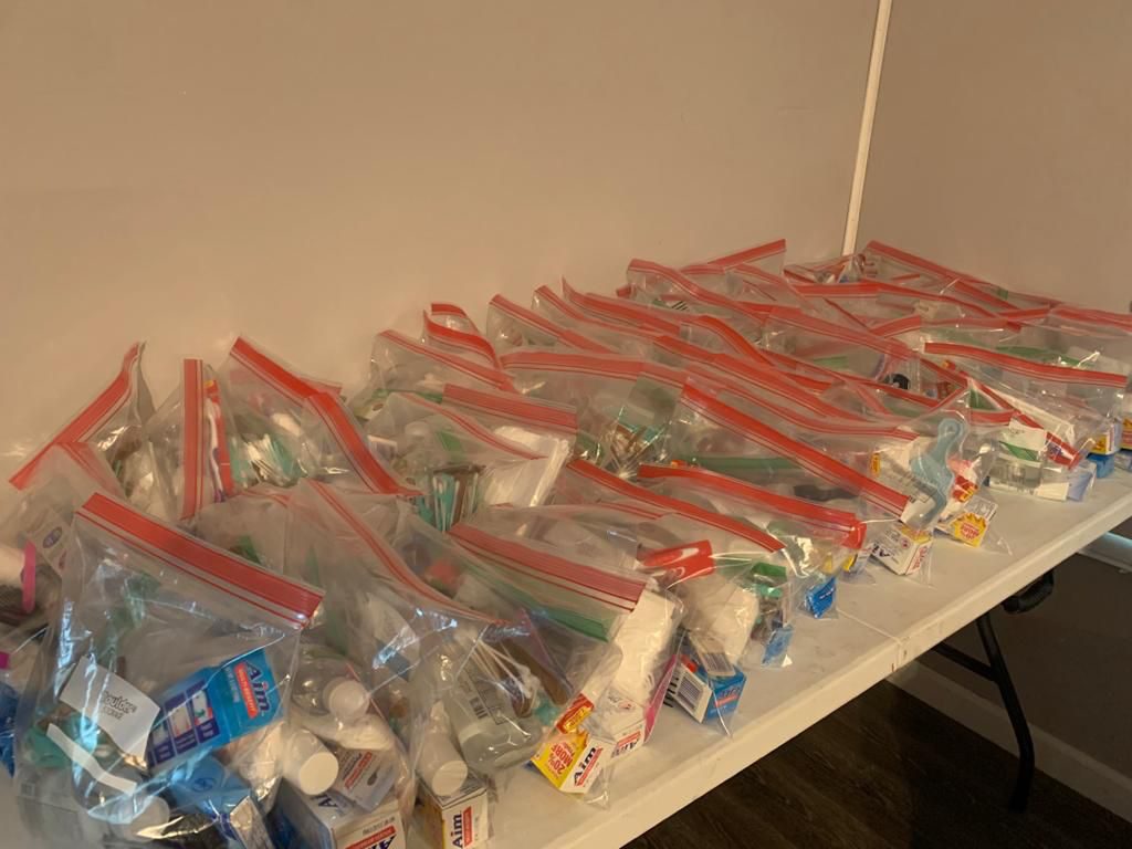 A table lined with packed hygiene kits